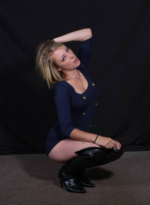 Kinky blonde Jay wearing a lovely short blue dress with thigh leather boots
