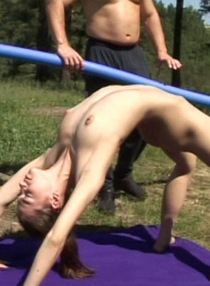 Horny instructor spreads naked gymnast's...